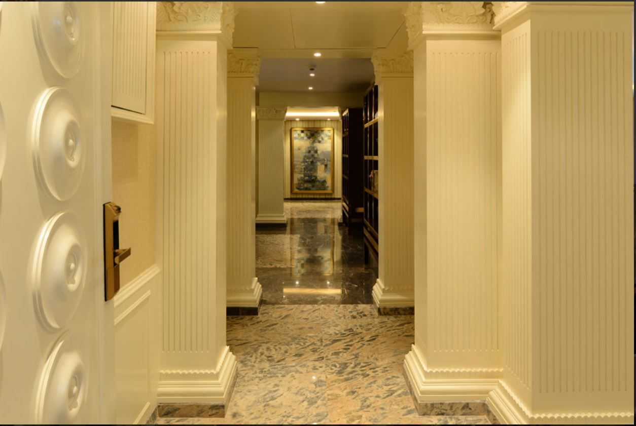 Foyer with fluted columns, carved capitals and marble flooring