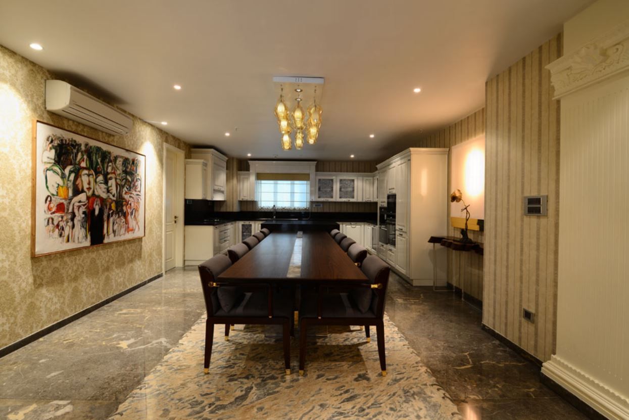 Formal dining room with statement chandelier and stone flooring