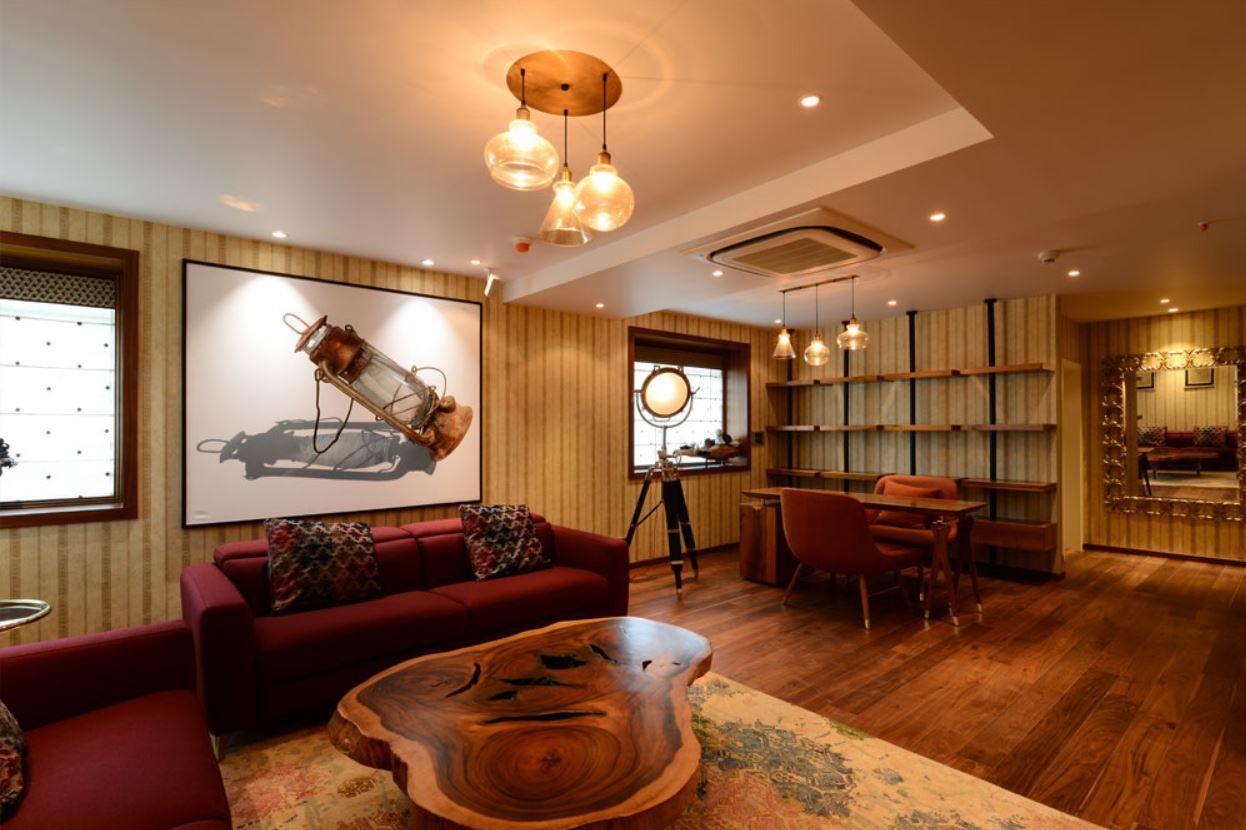 Reading lounge with industrial pendants and live-edge slab table